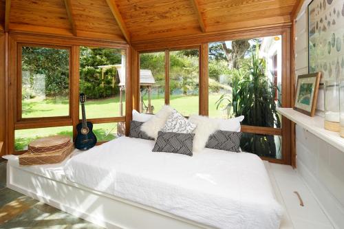 A bed or beds in a room at Oakura Bay Villa