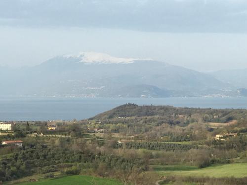 a large body of water with a mountain in the background at Hotel Villa Rosa in Sirmione