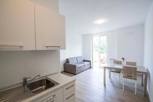 a kitchen with a sink and a table and a couch at Santa Caterina in Levanto