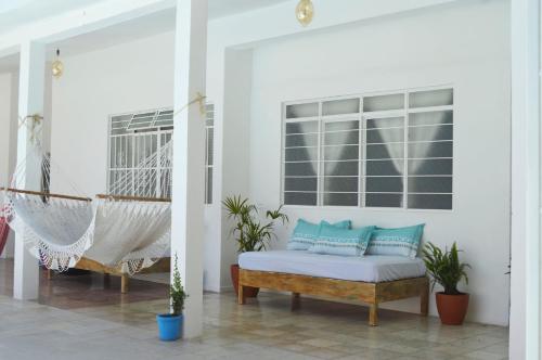 a room with a hammock and a swing at Casa Pancho Playa in San Francisco