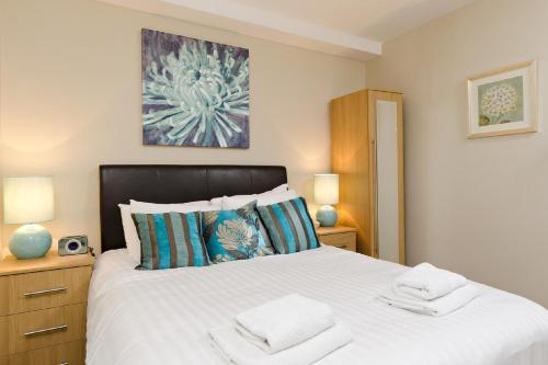 a bedroom with a bed with two towels on it at Hamilton Court Apartments from Your Stay Bristol in Bristol