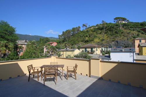 a patio with a table and chairs on a roof at Santa Caterina in Levanto