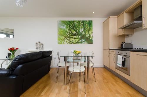 a living room with a table and a couch at Hamilton Court Apartments from Your Stay Bristol in Bristol