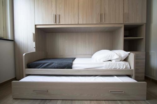 a large bed in a room with wooden cabinets at Santa Caterina in Levanto