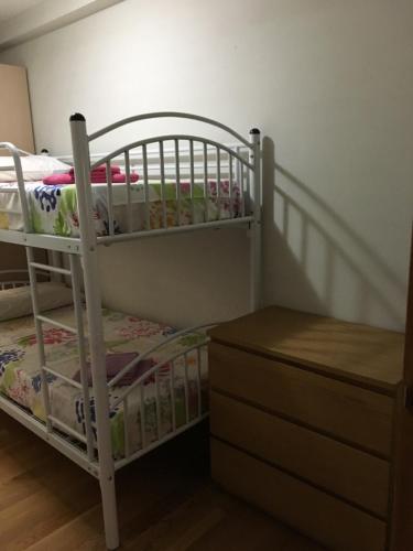 a white bunk bed in a room with a dresser at Bidasoa by Basquelidays in Irún