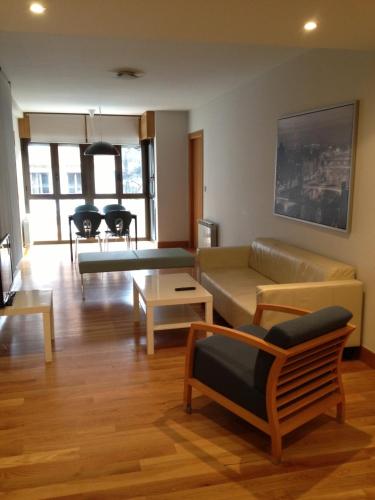 a living room with a couch and a table at Bidasoa by Basquelidays in Irún