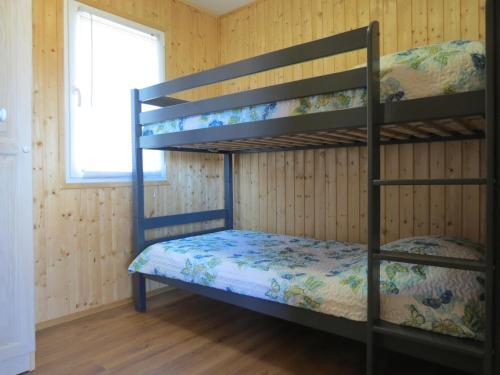 a bunk bed room with two bunk beds and a window at Campsite Kaya in Pakoštane