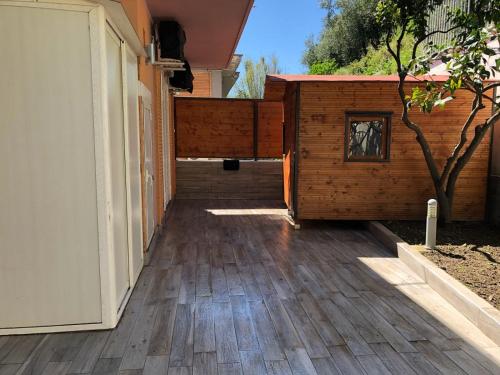 a patio with a wooden floor and a building at Villa Giulia in Pozzuoli
