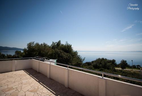 a balcony with a view of the water at Apartmani Tomic in Zavalatica