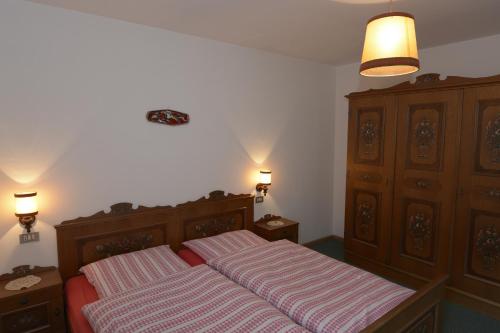 a bedroom with two beds and two night stands at Trafisolerhof in Vols am Schlern