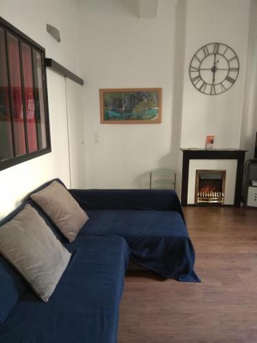 Ce lit se trouve dans un dortoir doté d'une horloge murale. dans l'établissement La Maison de Valentino, à Marseille