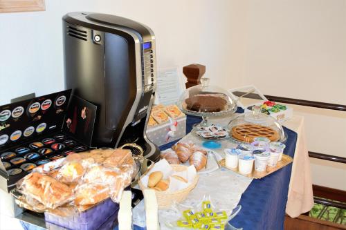 a table topped with bread and pastries on a table at B&B Kenzia in Olbia