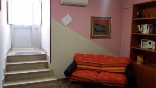 a living room with a staircase and a couch at Affittacamere di Fabio Principale in Talsano