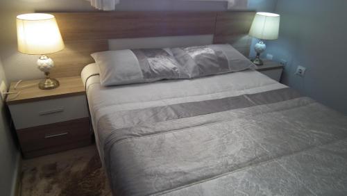 een slaapkamer met een groot bed met 2 lampen erop bij Sea view Apartament in La Mata