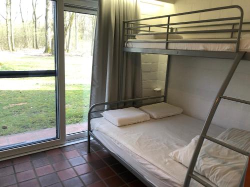 a bedroom with two bunk beds and a window at Ceder 9 Hengelhoef in Houthalen-Helchteren