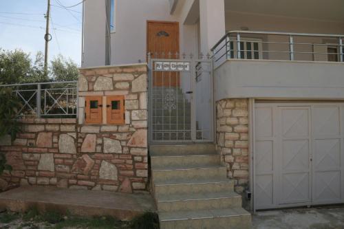 a house with a gate and a garage at MyKsamil Apartments in Ksamil