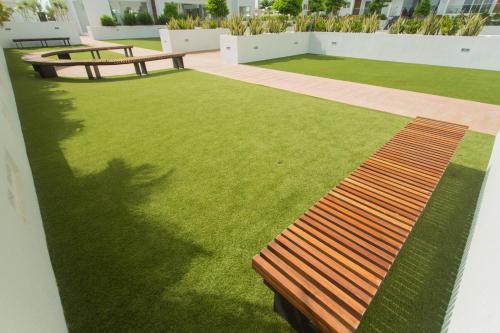 a bench sitting on top of a green lawn at Accra Luxury Apartments at The Gallery in Accra