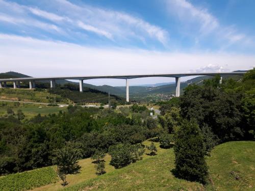 a bridge in the sky over a field with trees at Apartment Beautiful Črni Kal in Črni Kal