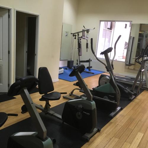 a gym with several treadmills and exercise bikes at Suites Parque Real in Quito