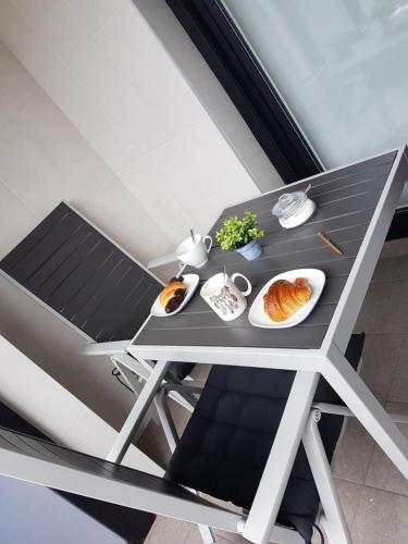 a dining table with plates of food on it at Smart Urban Orio in Orio