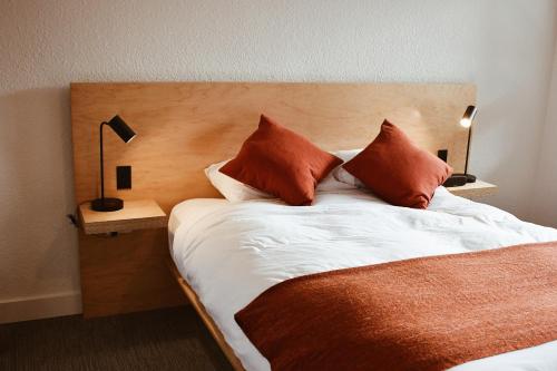 a bed with two pillows on it in a room at Heliotrope Hotel in Bellingham