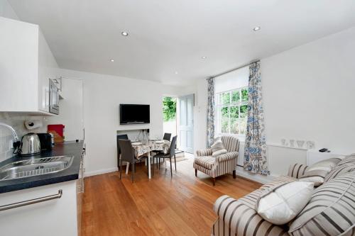 a kitchen and living room with a table and chairs at The Apartment, 24 West End Terrace, Winchester in Winchester