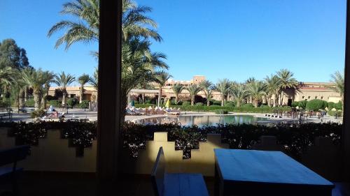 a view of a resort with palm trees and a pool at Belere Arfoud in Erfoud