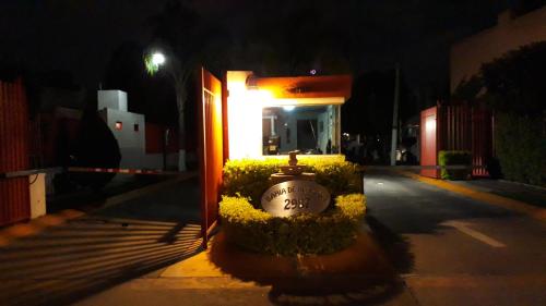 a light on a building with a clock in the middle at Casa Ejecutivo Zona Iteso Bahía de Acapulco in Guadalajara