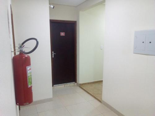 a room with a fire hydrant next to a door at Fit hotel in Dourados