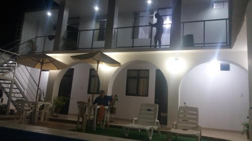 a man sitting at a table in front of a building at La Maison de Lydia in Nazca