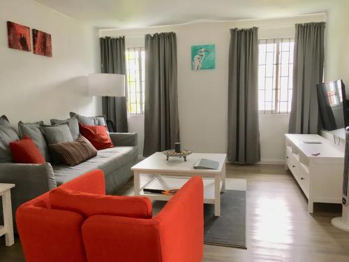 a living room with a couch and a table at Dover Woods Apartments in Christ Church