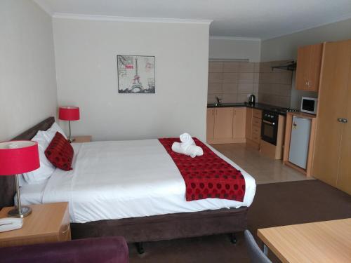 a bedroom with a bed with a teddy bear on it at Parkdale Motor Inn in Parkdale