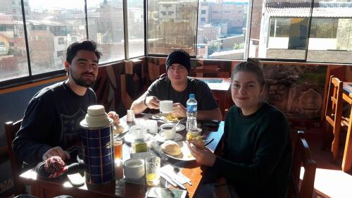 a group of people sitting at a table eating food at Hotel Tamia in Huaraz