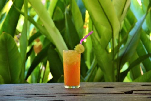a drink sitting on a table with a lime in it at Forra Dive Resort Sunrise in Ko Lipe