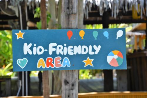 a blue sign that says kid friendly area at Forra Dive Resort Sunrise in Ko Lipe