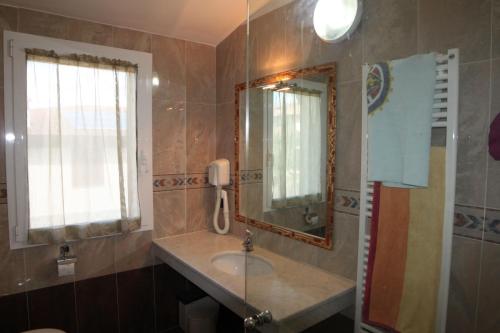 a bathroom with a sink and a mirror at Holiday home Villa Bobolino in Montelupo Fiorentino