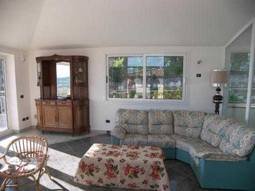 a living room with a couch and a table at Holiday Home Villa Bobolino in Montelupo Fiorentino