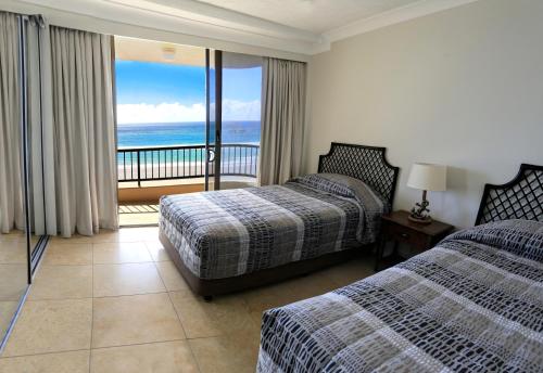 A bed or beds in a room at Pelican Sands Beach Resort