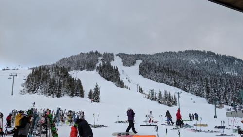 a group of people on a snow covered ski slope at White Pass Log Cabin Luxury Retreat in Rimrock