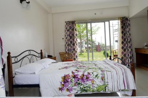 A bed or beds in a room at Upasana Eco Resort