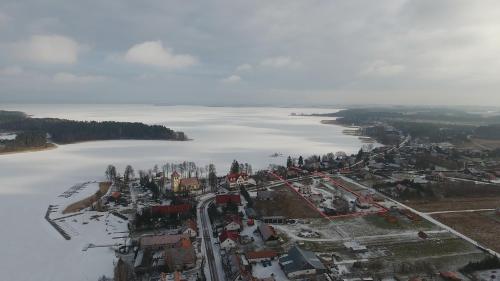 an aerial view of a town next to a body of water at Sterburta in Rydzewo