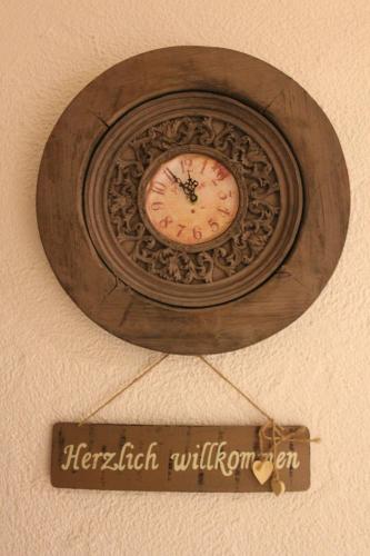 a clock on a ceiling with a sign on it at Gästehaus Chaplin in Kempten