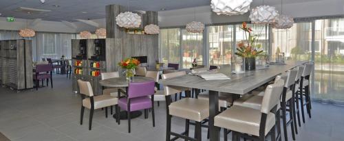 a dining room with a long table and chairs at Best Western City Hotel Woerden in Woerden