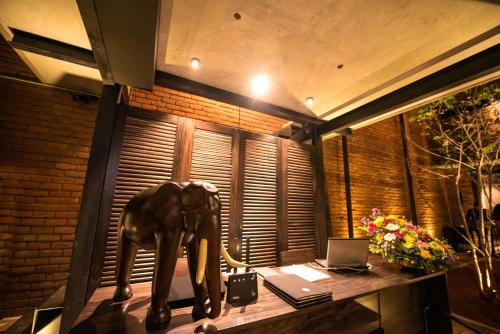 a statue of an elephant on a desk with a laptop at BBQ HUB Ella in Ella