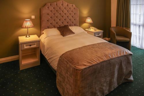 a hotel room with a large bed and a chair at Garrison Hotel in Sheffield