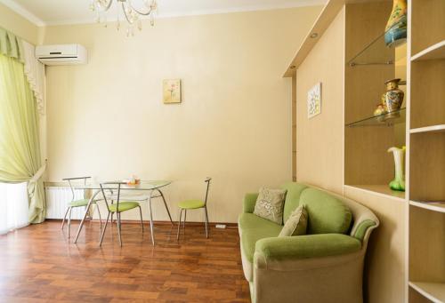 a living room with a green couch and a table at Kiev Centre Apartments in Kyiv