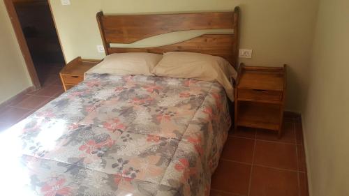 a bedroom with a bed with a wooden headboard at Casa roko in Puntagorda