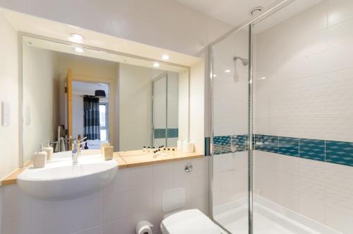 a bathroom with a sink and a toilet and a shower at Hamilton Court Apartments from Your Stay Bristol in Bristol