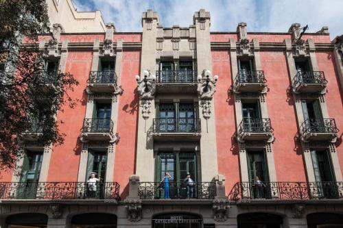 a large red building with people standing on balconies at Catalonia Catedral in Barcelona