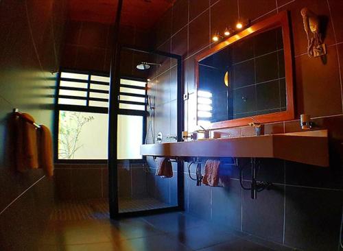 a bathroom with a sink and a window at Hôtel Serena in Toliara